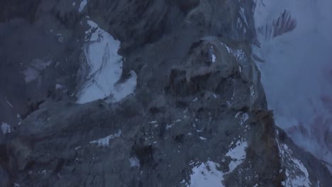 rugged landscape of the matterhorn before sunlight with pockets of snow