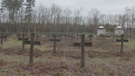 tilt down from grey sky to old crosses at cemetery