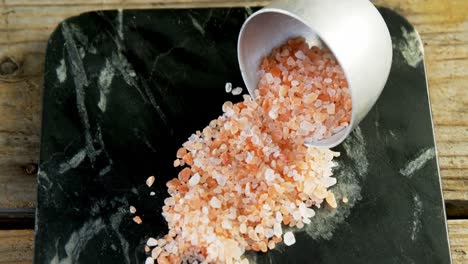 himalayan salt spilling out of bowl 4k