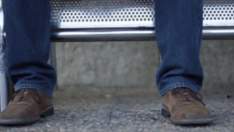 the man waiting with a leather suitcase