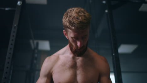 he already looking for the next challenge. tired muscle athlete. tired man having rest after workout. tired and exhausted male athlete sitting on floor at gym with a water bottle.