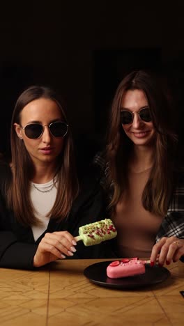 two women enjoying desserts