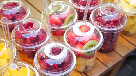 colorful fruit salad cups at a market