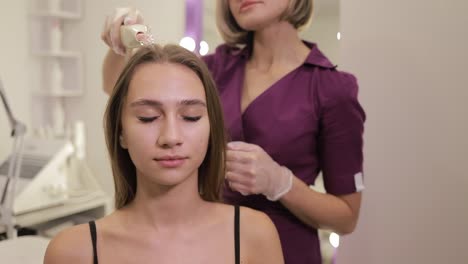 woman with beautiful smile getting hair done in trendy salon. a woman’s smile lights up the beauty salon as she gets her hair done by a hairdresser, relaxing her muscles and tilting her head comfortably