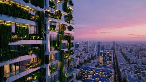 Aerial video angle of a modern cityscape at sunset, featuring a building with lush vertical gardens