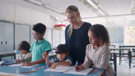 Young-school-teacher-checking-task