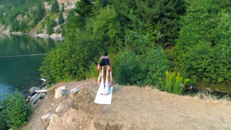 two women practice acroyoga 4k