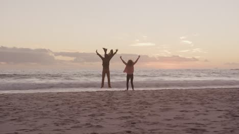 pareja de ancianos activos saltando en la playa