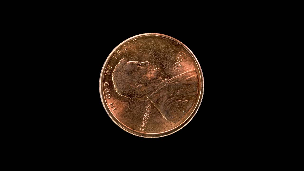 United States 1989 1 cent coin obverse with Abraham Lincoln portrait rotating on black background