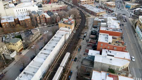 train on railroad tracks for commuters using public transportation in chicago, aerial view