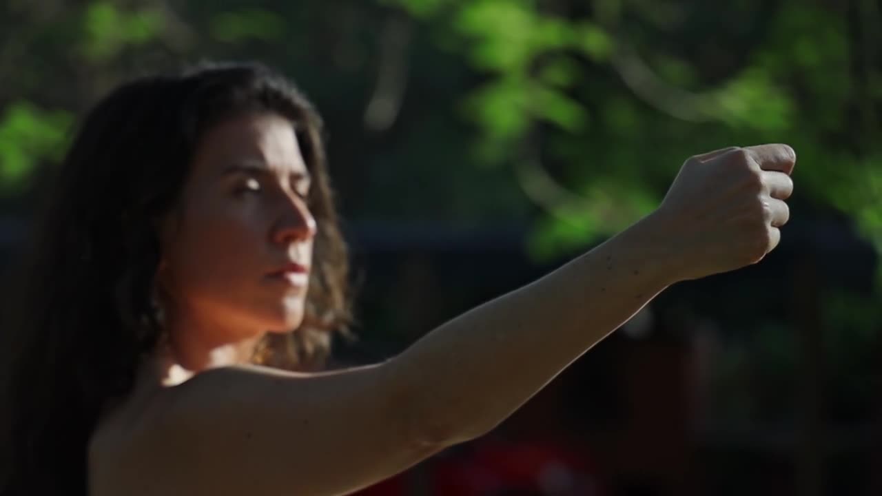 Woman outdoors doing Spanish dance moves with her hand. Close up, slomo