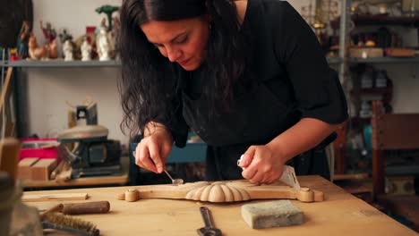 carpenter applying glue on wooden detail