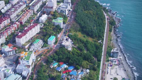 busan city coastline beach trainline and apartments, high overhead establishing shot, south korea