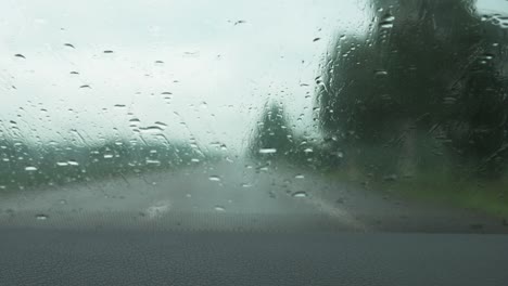 Parabrisas-Delantero-Del-Coche-Con-Gotas-De-Lluvia-Mientras-Conduce