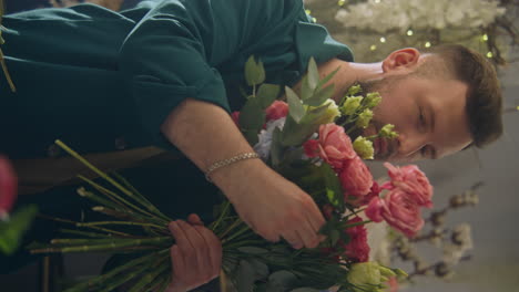 florist collects bouquet and looks at camera