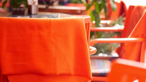 orange cafe chairs and tablecloths