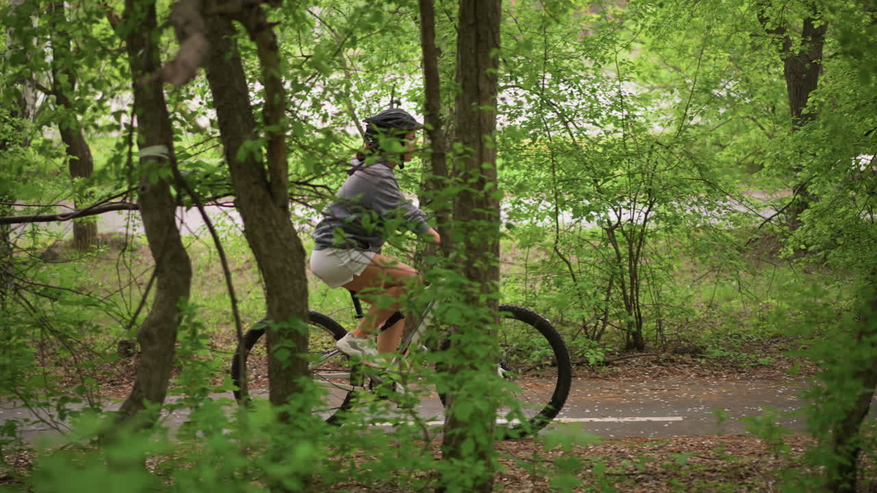 Rider Explores Dense Forest Trails, Mountain Biker Traverses Winding Paths In Lush Forested Areas, Cyclist Ventures Into Dense Green Woods Navigating Challenging And Scenic Forest Routes