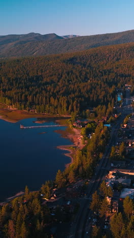 stunning scenery of beautiful lake tahoe on sunny warm day. waterfront with all the necessary infrastructure and blue water of lake with numerous boats. top view. vertical video