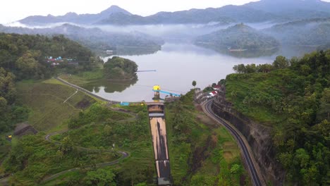 fly over dam water gate on the sermo dam in the foggy morning