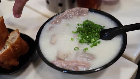 delicious congee with green onions and bread