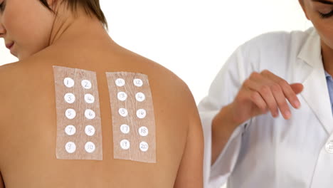 woman therapist writing something on the back of her patient