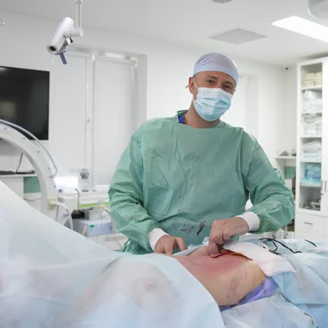 end of liposuction operation. surgeon does the finishing procedures before the patient wakes up. doctor cleans the patient's abdomen and comments the operation