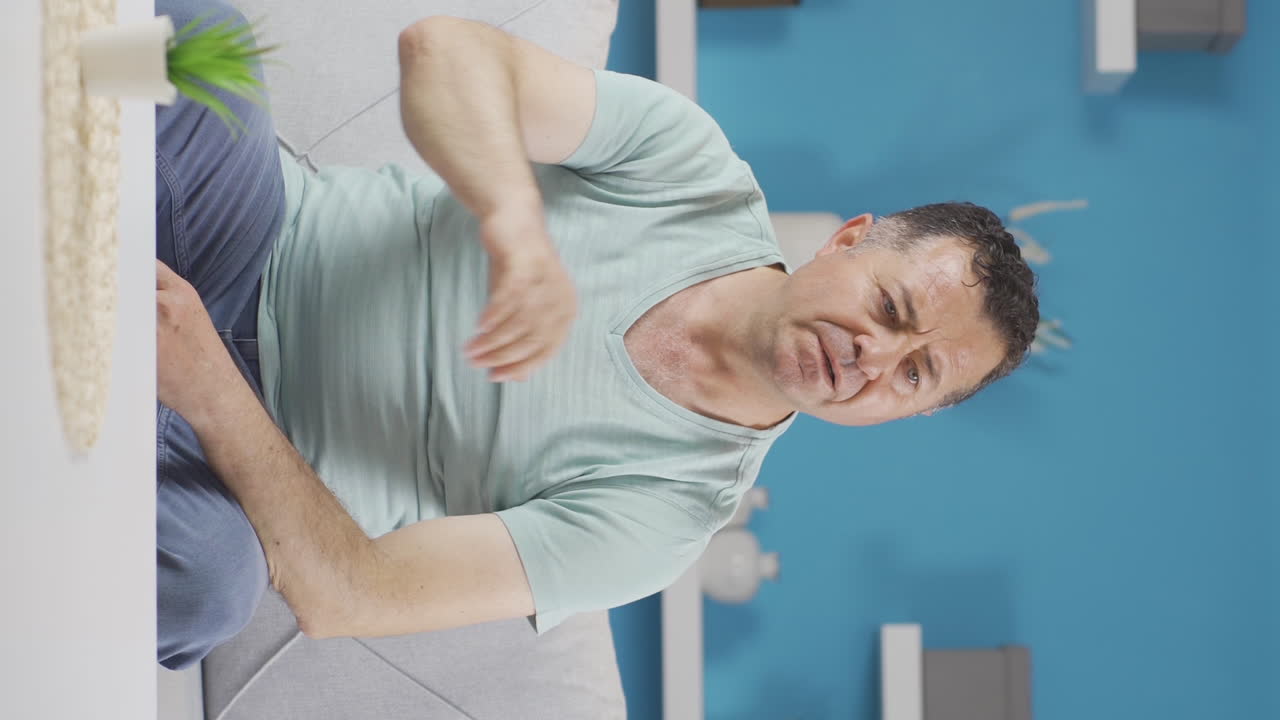 Vertical video of Frustrated old man gets angry.