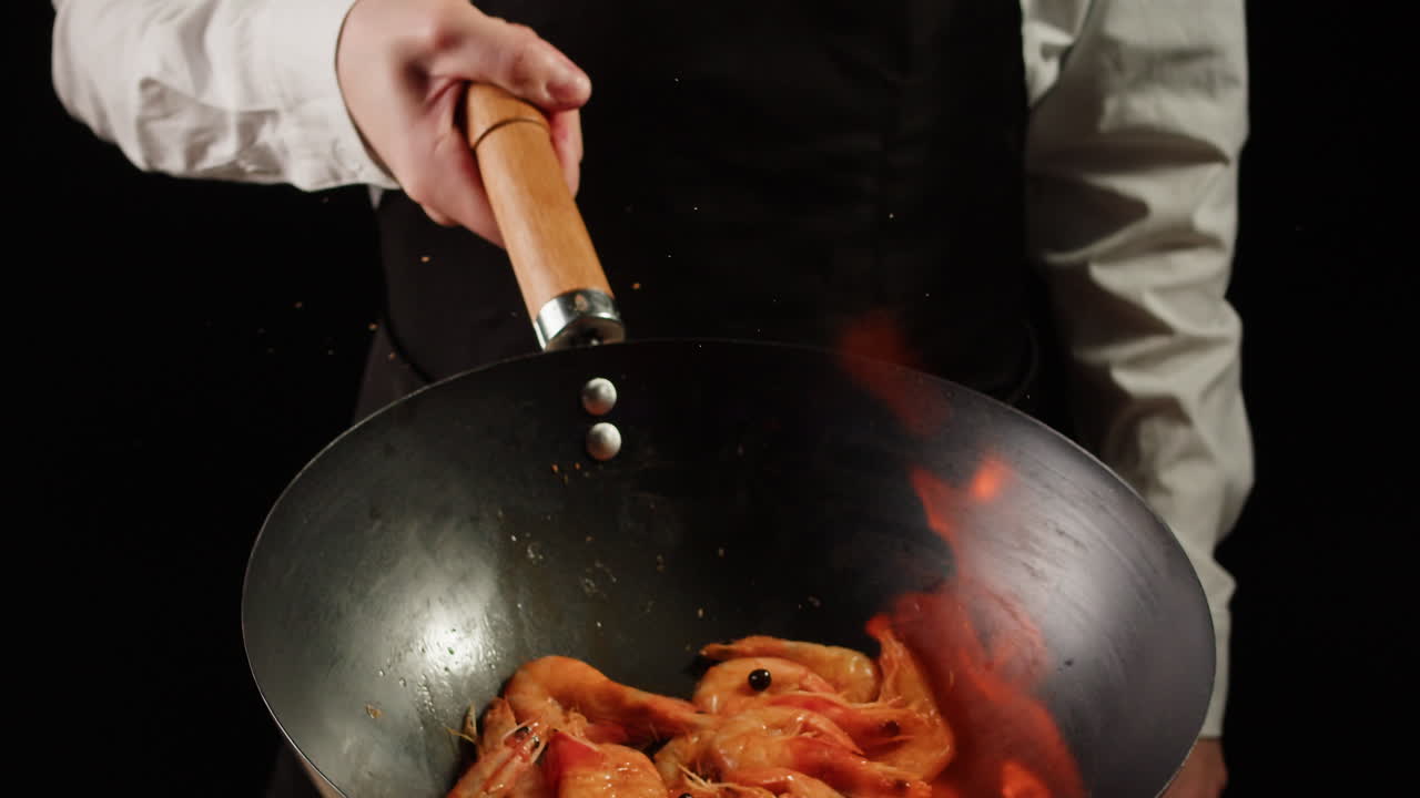 Chef Cooking Shrimp in Wok with Fire