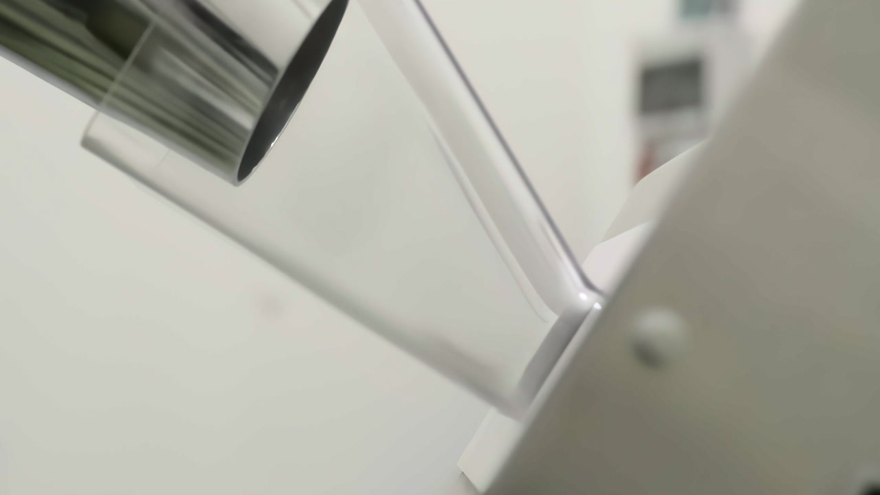 Close-up footage of capsules flowing and falling into a collection bag during pharmaceutical production.