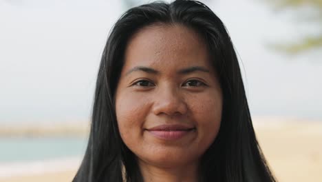 southeast asian woman brushing her hair with fingers