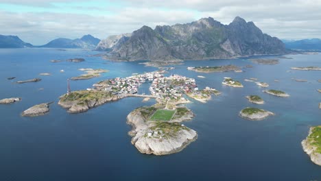 henningsvaer soccer field and village in lofoten island archipelago, norway - 4k aerial