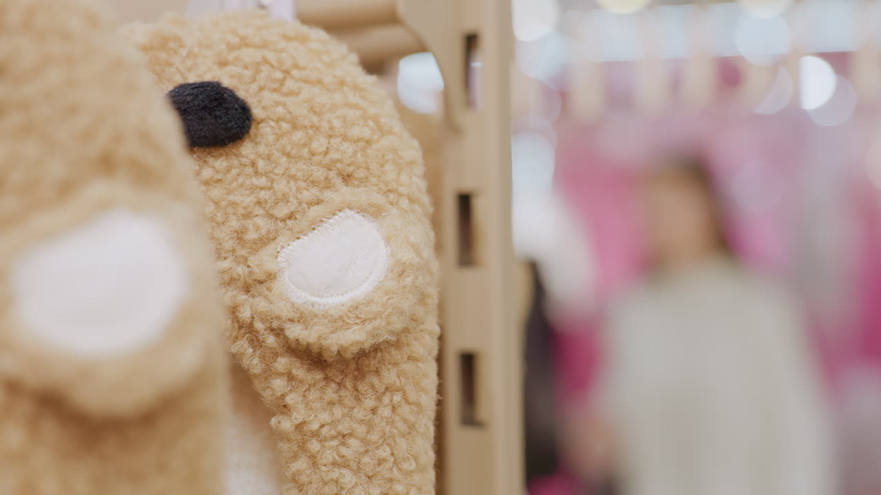 Close-up of a toy with soft bokeh effect, while people walk in the background in a busy mall, creating a lively and dynamic shopping atmosphere