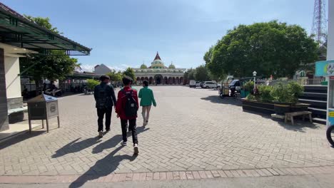 congregants enter through the main gate of the ponorogo grand mosque, east java, indonesia.