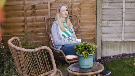 woman drinking tea in the backyard