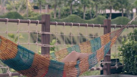 lady-with-perfectly-tanned-long-legs-relaxes-in-hammock