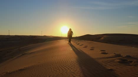 silhouette: a man walks alone in the arabian desert of the united arab emirates, landscape video of the gulf desert, uae desert