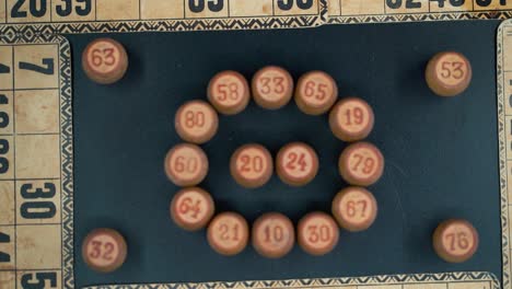 cinematic close-up smooth zoom out, shot from above of a bingo wooden barrels in a circle, woody figures, old numbers background, vintage board game, professional lighting, slow motion 120 fps