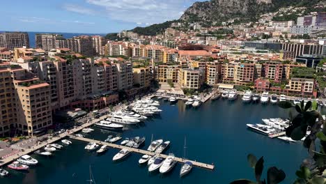 panoramic drone shot of fontvieille district of monaco with marina and luxury yachts. sunny day in summer season with upper class houses and neighborhood, france. top down.