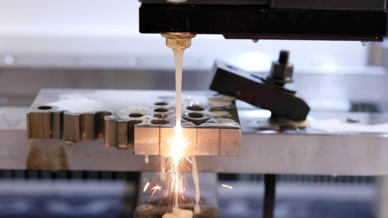 Close-up of a Wire Electrical Discharge Machining (WEDM) process on a metal workpiece, creating sparks during cutting