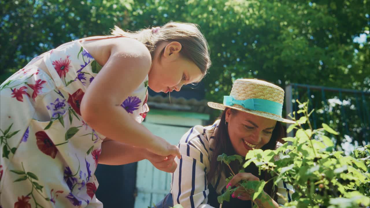 Mother and daughter gardening together in the summer