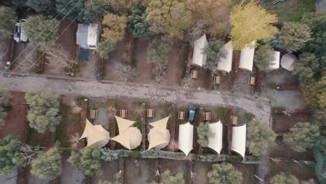 rising drone flight over typical small tents and parking near the canales reservoir in güéjar sierra in spain