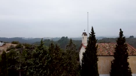 Aerial-Rising-Over-Trees-To-Reveal-Castellbisbal-Landscape