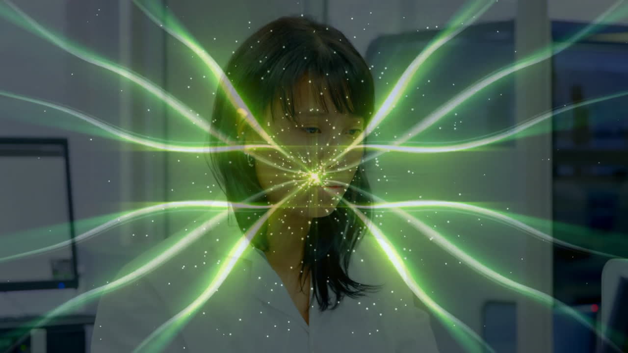 In laboratory, woman working with green energy waves animation surrounding her