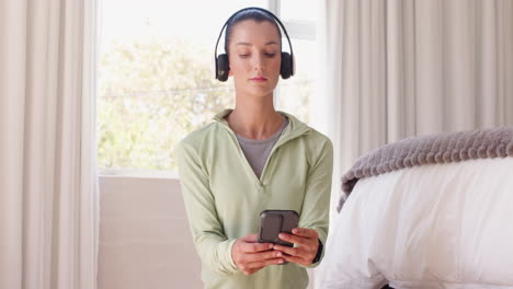 woman wearing headphones relaxing at home, enjoying peaceful moment by window