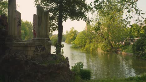 trees around the ixelles ponds on a breezy day, public park in ixelles, brussels, belgium