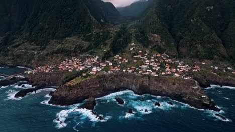 aerial view of a coastal town on a dramatic cliffside
