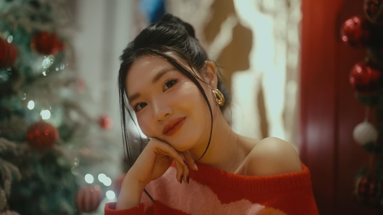 Woman posing in front of Christmas tree