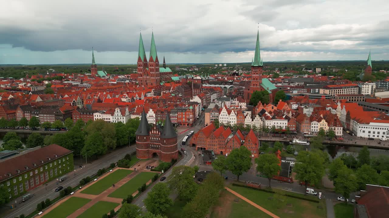 aerial shot around lubeck city center with the holstentor gothic gate in the foreground and the city center with churches in the background, Lubeck city, Schleswig-Holstein land, Germany