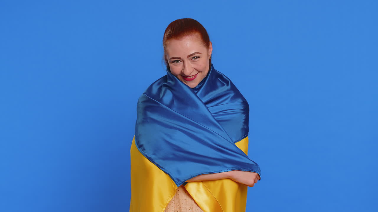 Adult smiling woman hold ukraine national flag hoping for success independence freedom victory