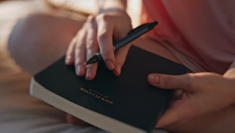 hand making handwriting notes closeup. girl holding pen planning day in morning.